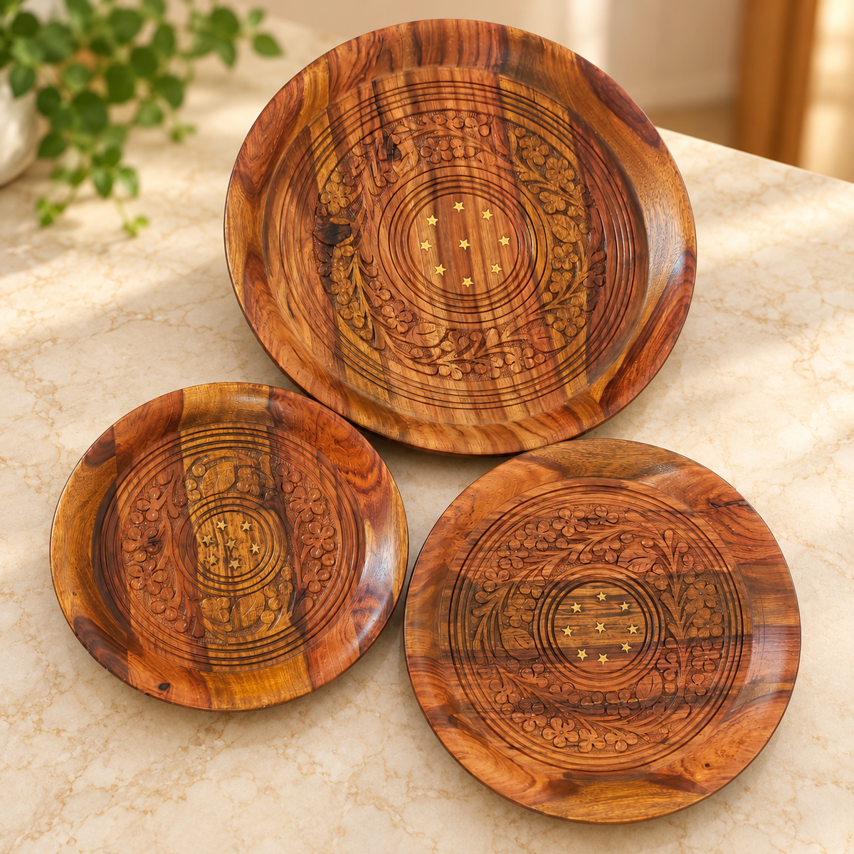 Set of three wooden plates with floral carving and star inlay details