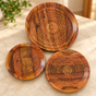 Set of three wooden plates with floral carving and star inlay details